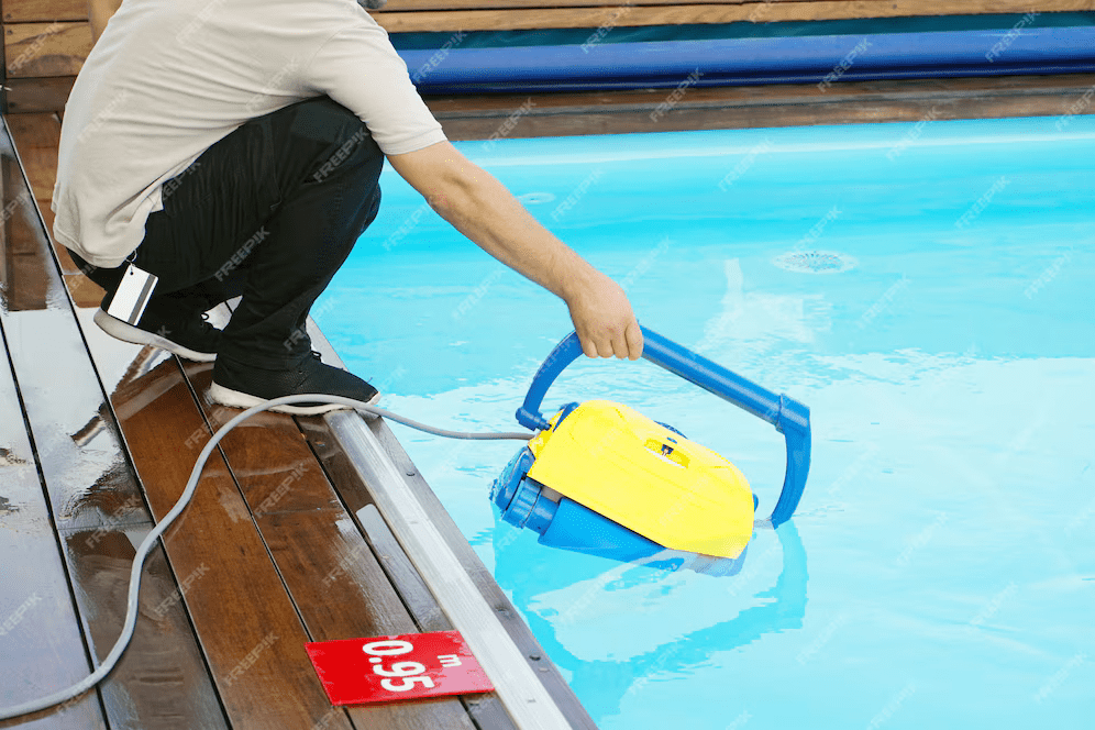 hotel-staff-worker-cleaning-pool-automatic-pool-cleaners_156719-555 hotel staff worker cleaning pool automatic pool cleaners 156719 555